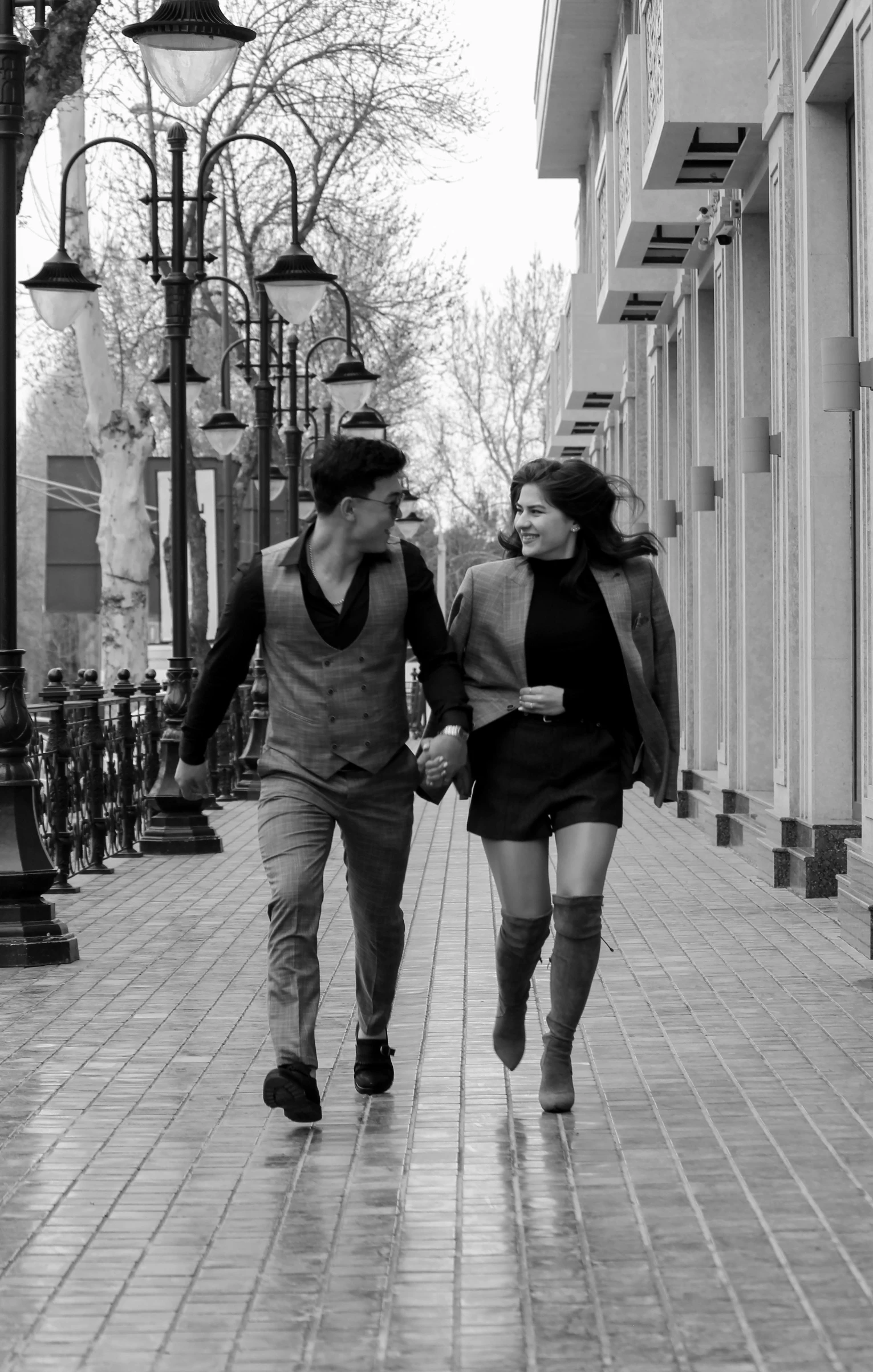 a man and woman walking down a street