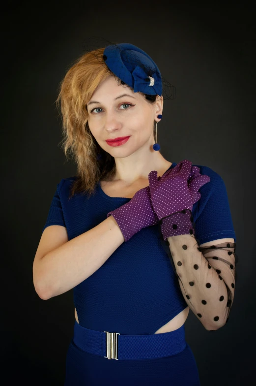 a lady holding up a pair of gloves to her chest