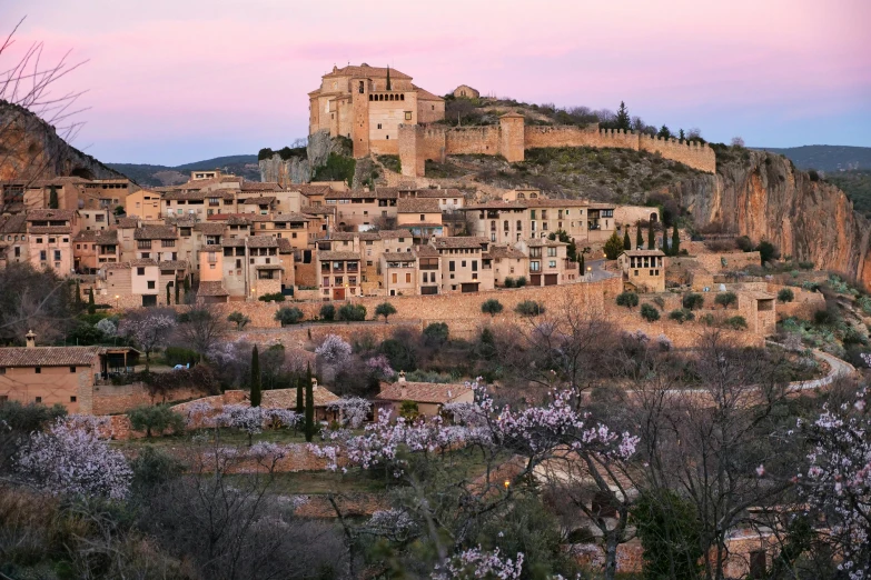 a very old city is perched on a cliff