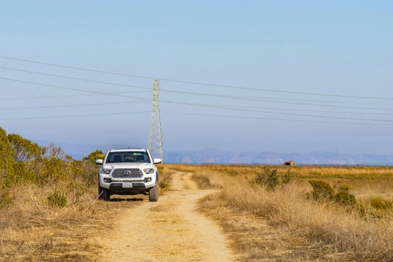 a vehicle parked in the middle of a dirt road