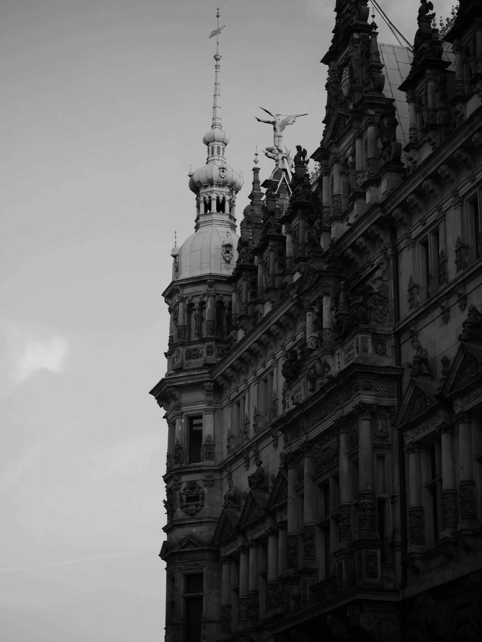 the tower of a large building has a clock on it