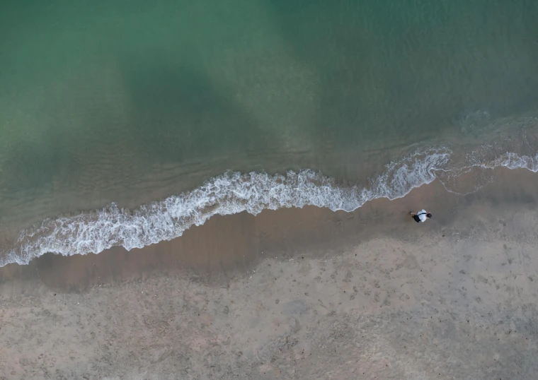 a sandy beach next to a small body of water