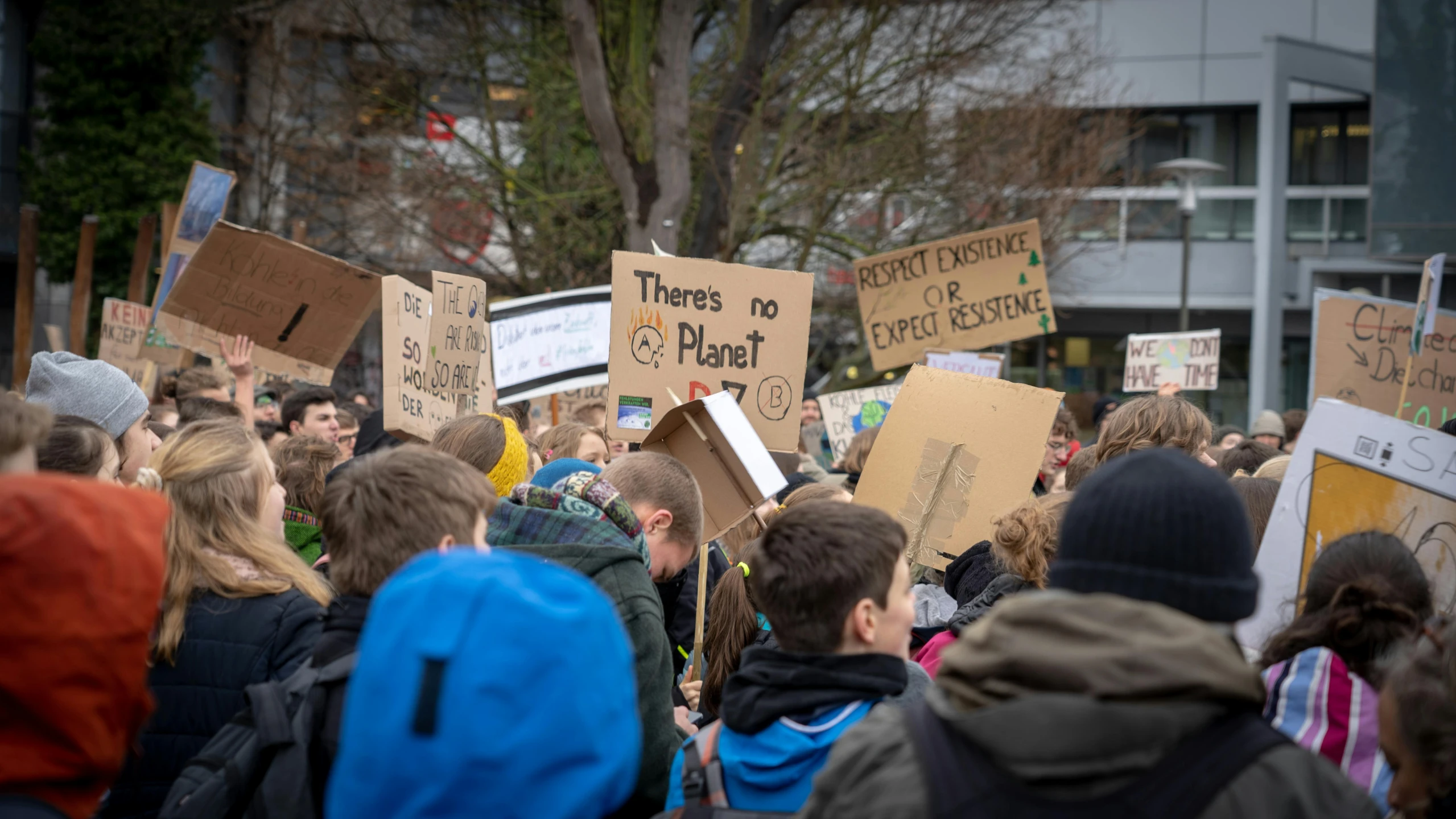 a protest with a few wooden signs on the sides