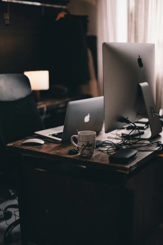 a couple of computer screens are on a desk