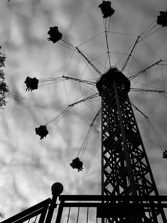 the ferris wheel is next to an outdoor structure