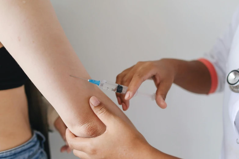 a nurse is examining the inside of an arm