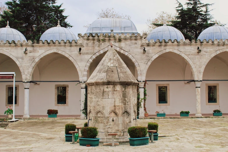 the courtyard of a building with some arches and towers