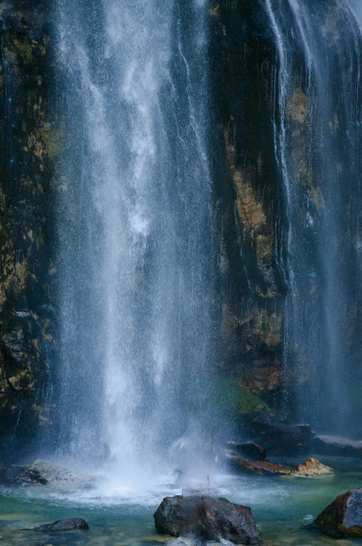 large waterfall with white spray hitting down top