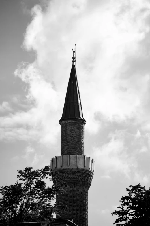 a large tower with a steeple with a cross on top