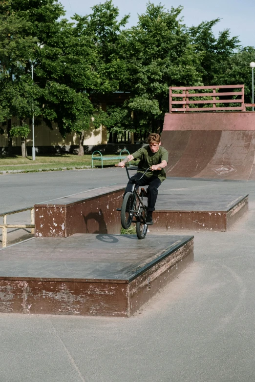 a boy on a bicycle is doing a trick