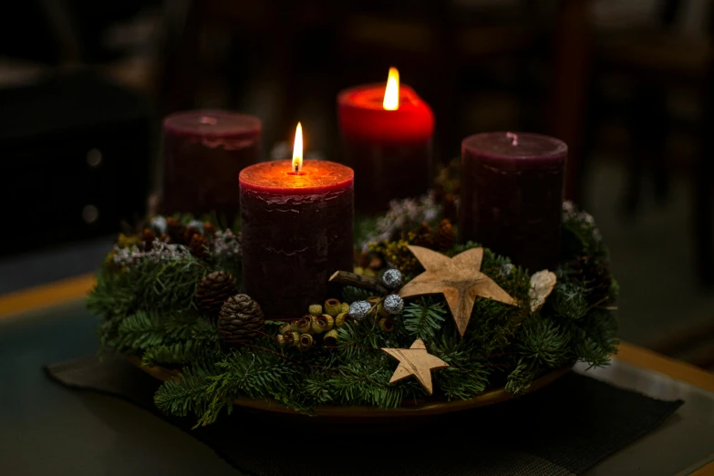 a set of three candles sitting on top of a table