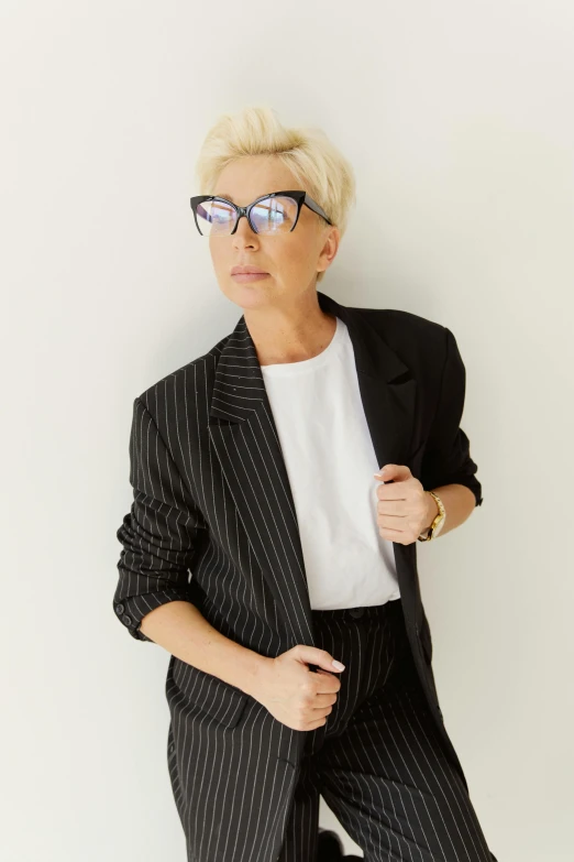 the woman with a short blond hair wearing glasses