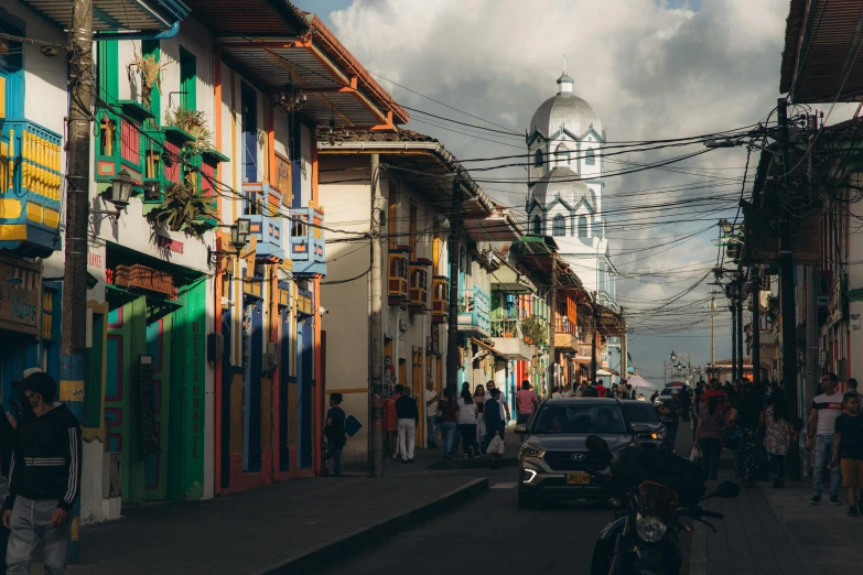 a street filled with lots of people and cars