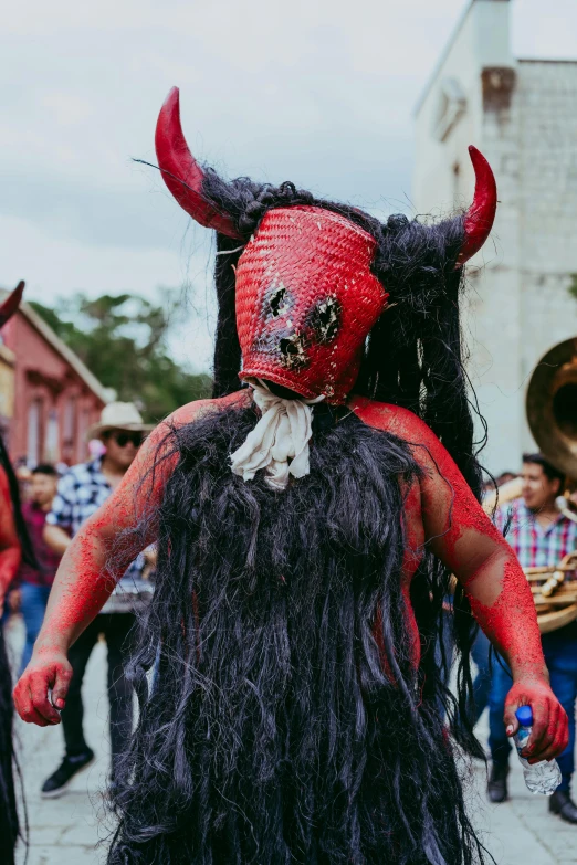 a man in a costume with a beard and horns