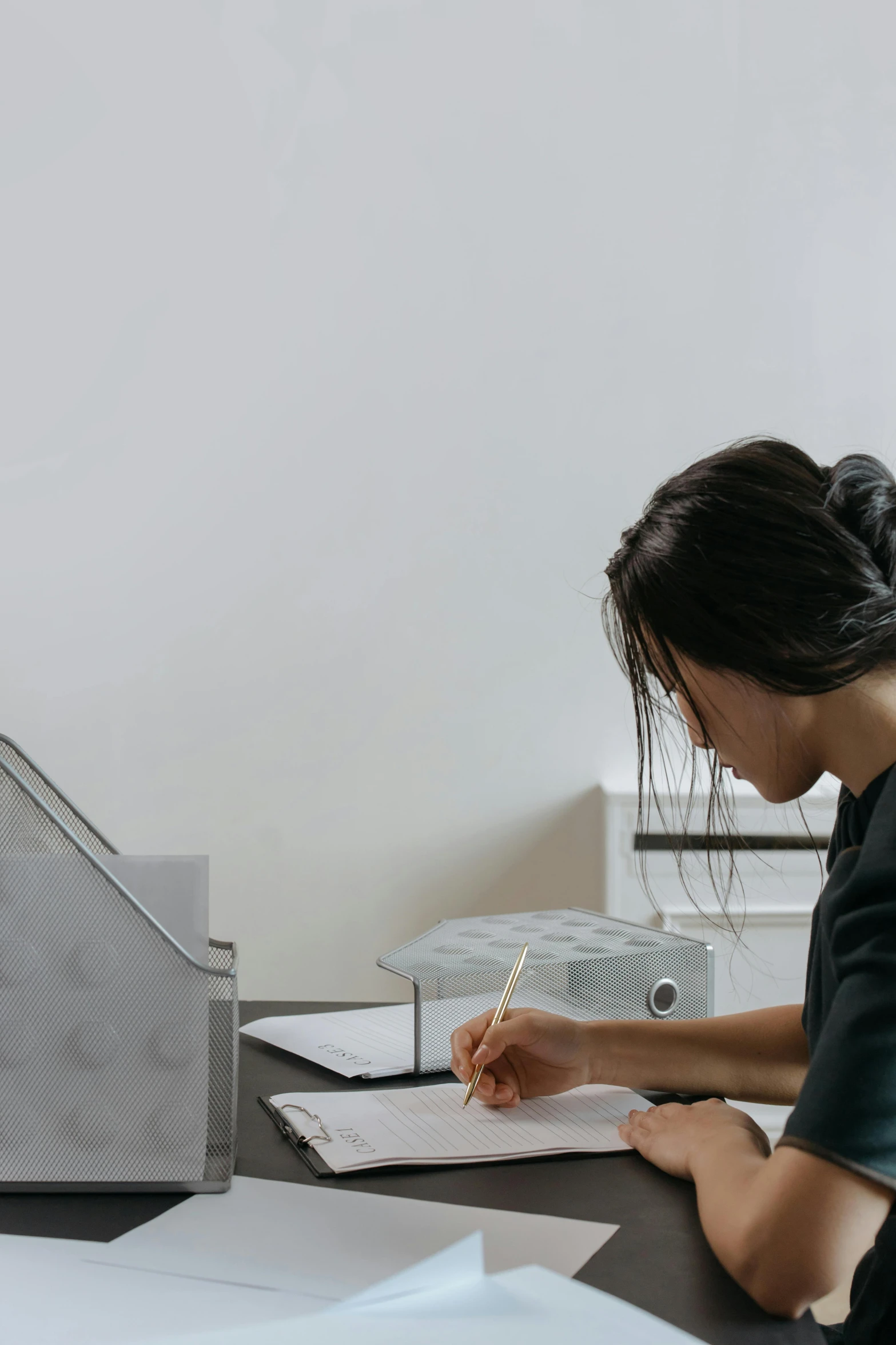 woman sitting at desk working on her notebook