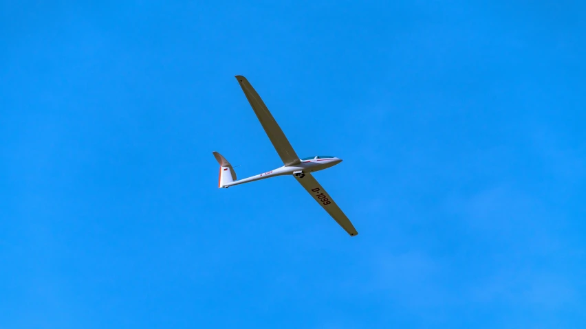 a plane flying in the sky with the propeller extended