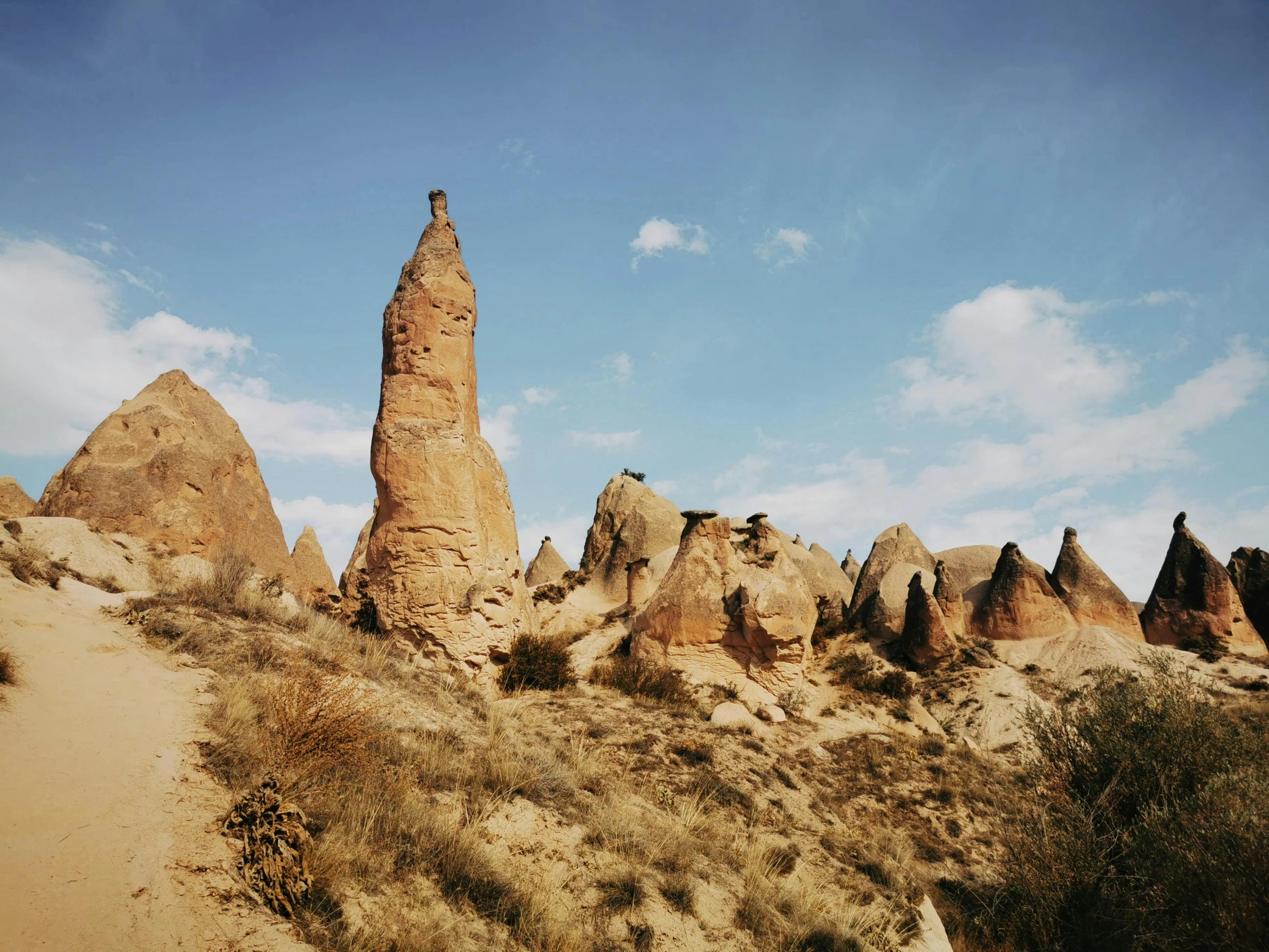 many rocks and mounds in the desert with blue sky in background