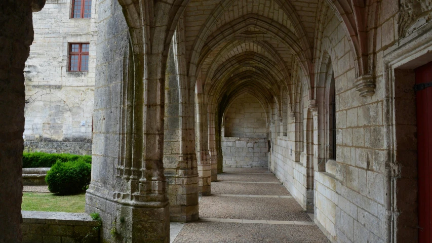 an old hallway with arches and pillars in the middle