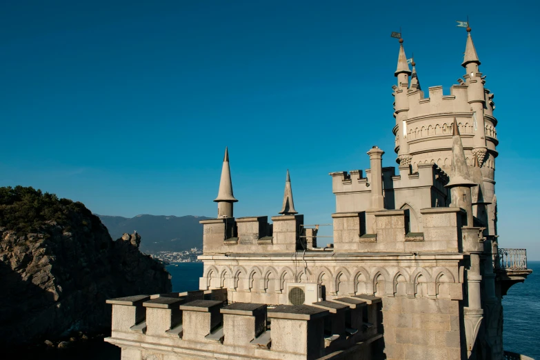 an old castle with turrets overlooking the ocean