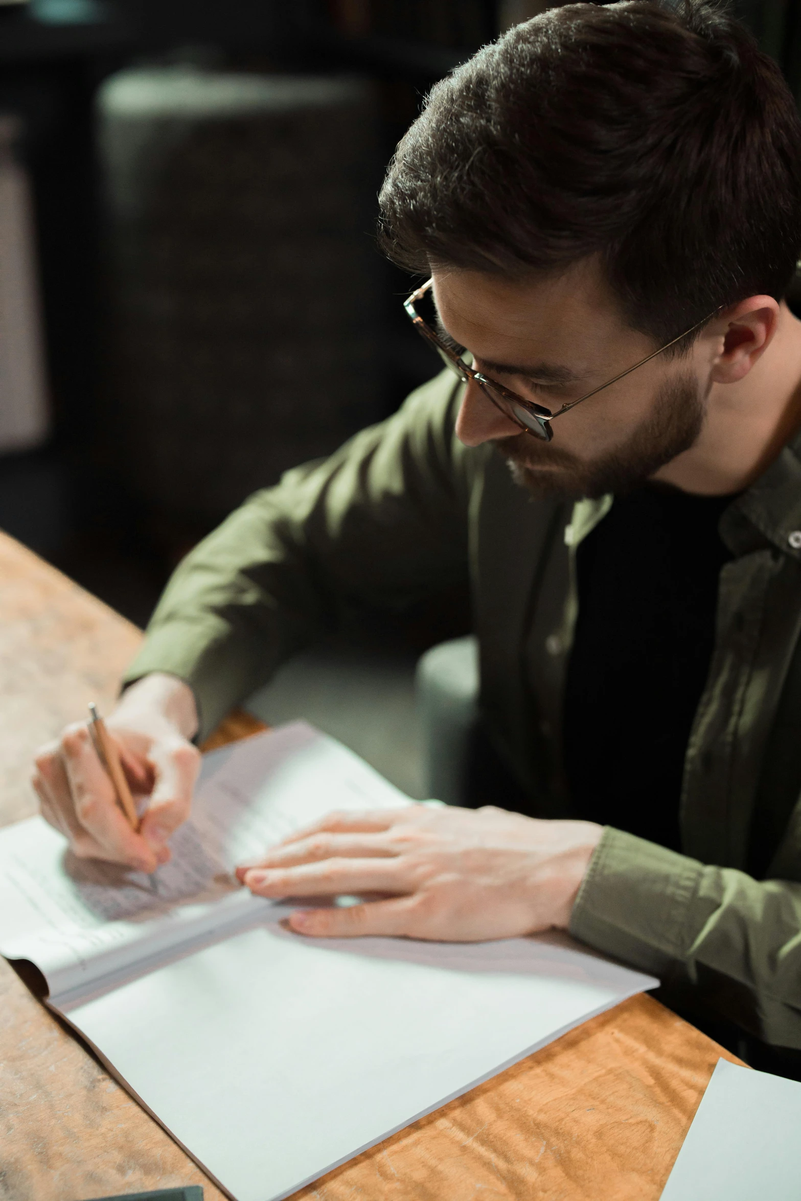 a man sitting at a table using a cell phone