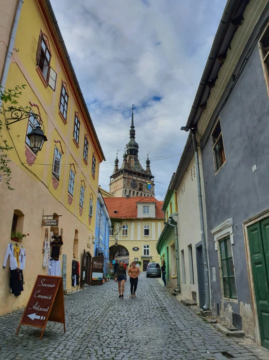 several people are walking around an old european village