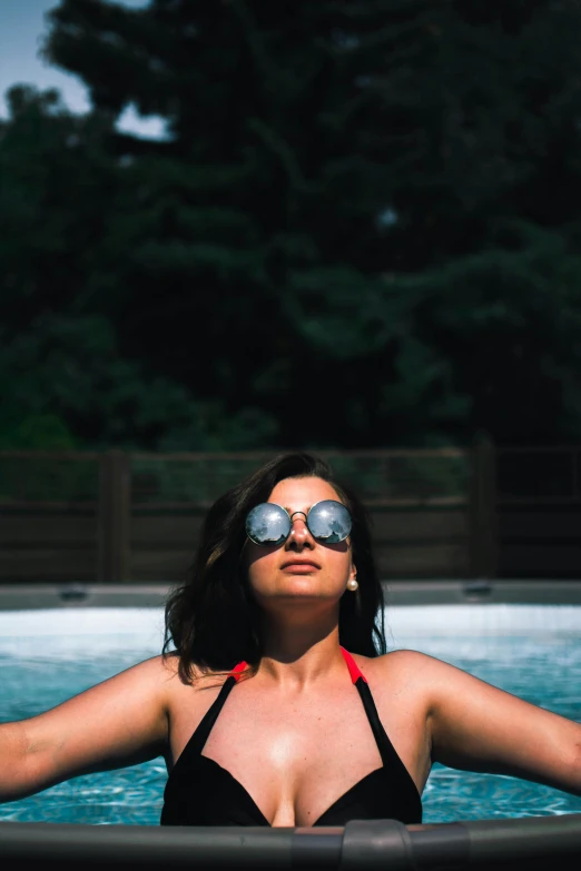 a woman in a red bikini swims in the water