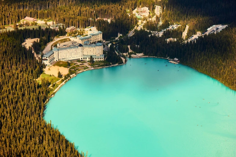 an aerial view of a blue mountain lake