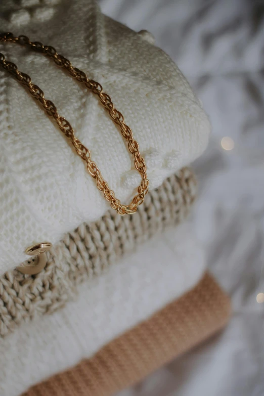 sweaters, a chain and a ring on display