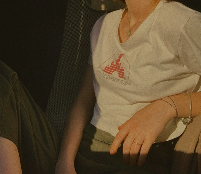 a woman sitting down in front of a tv