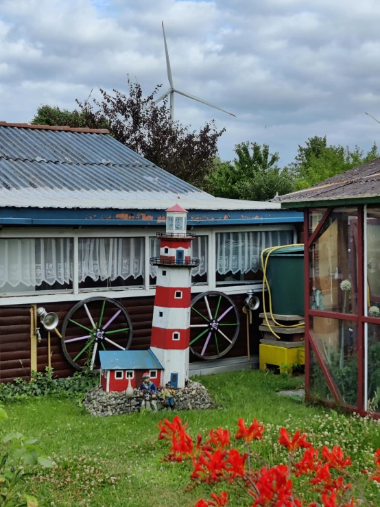 a lighthouse model sitting on top of a lush green field