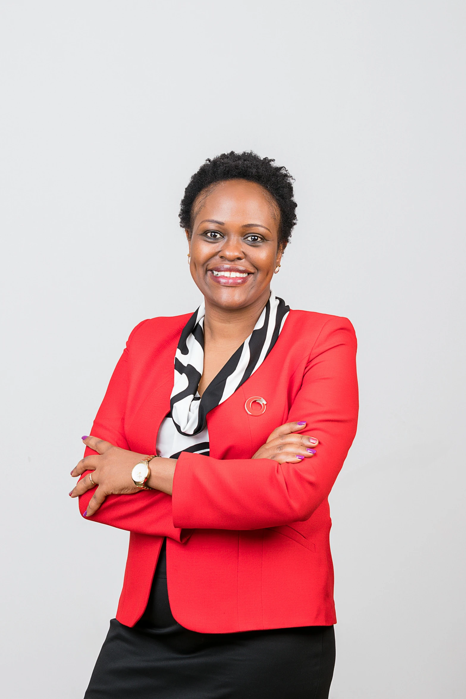 an african woman in a red jacket is posing for the camera