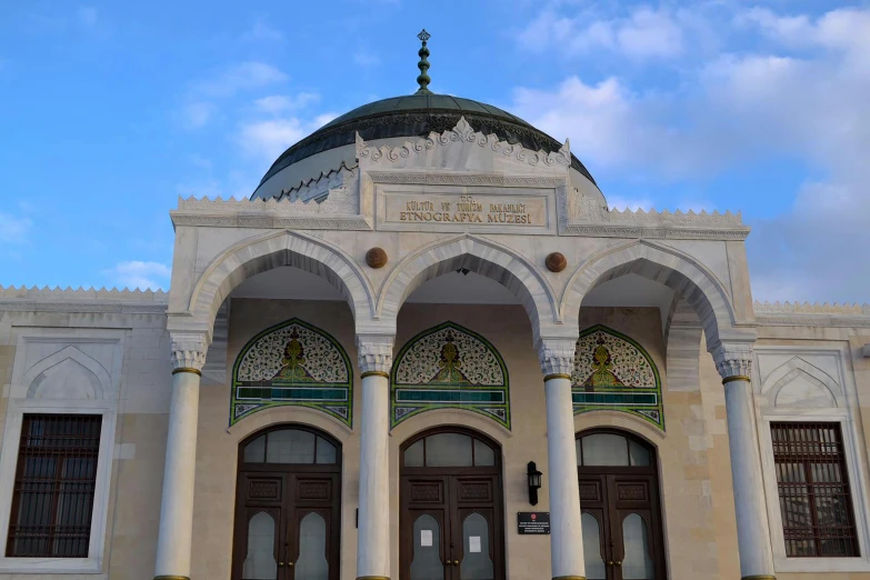 a building with arches and arched doors that have ornate details