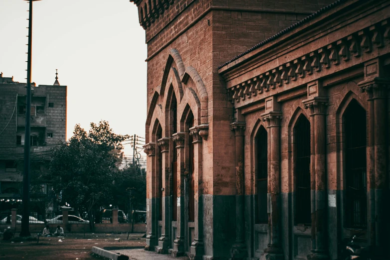 a building with arches and a clock tower near it