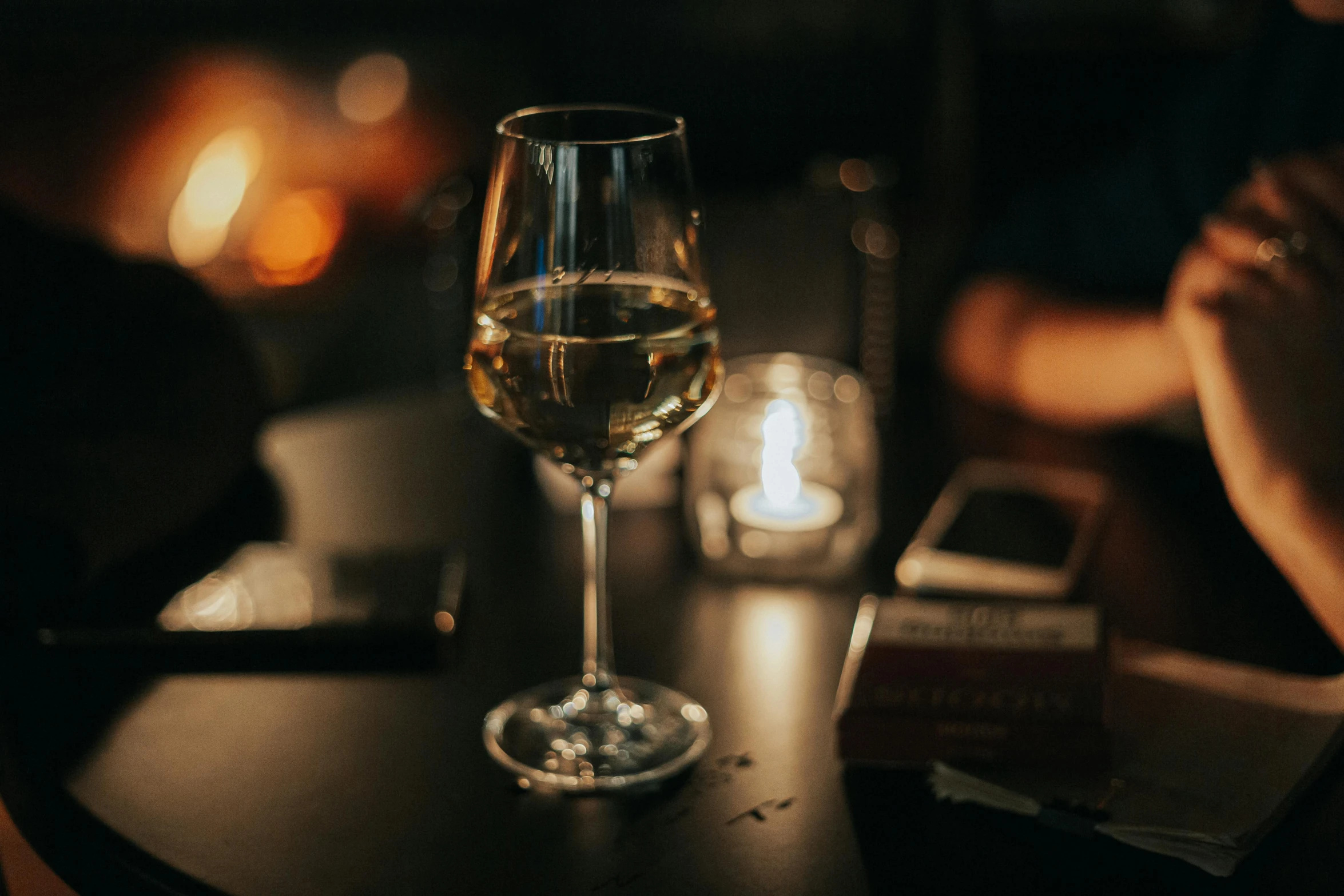 a glass of wine sitting on top of a table