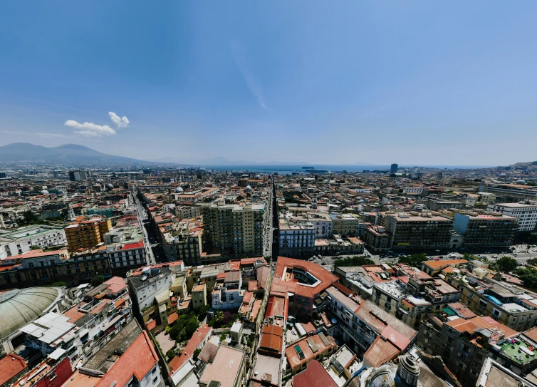 a view from a tower with rooftops and city buildings