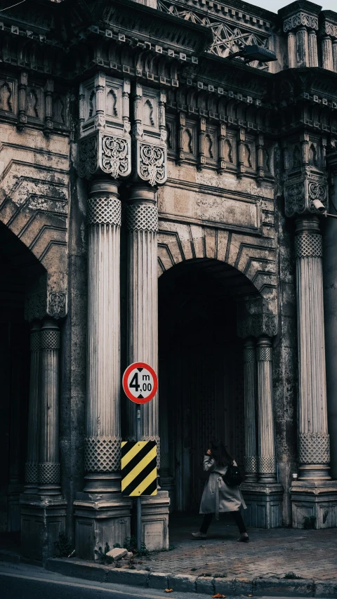 a man is sitting on a bench in front of a building