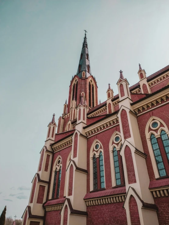 large brick building with a spire made of stone