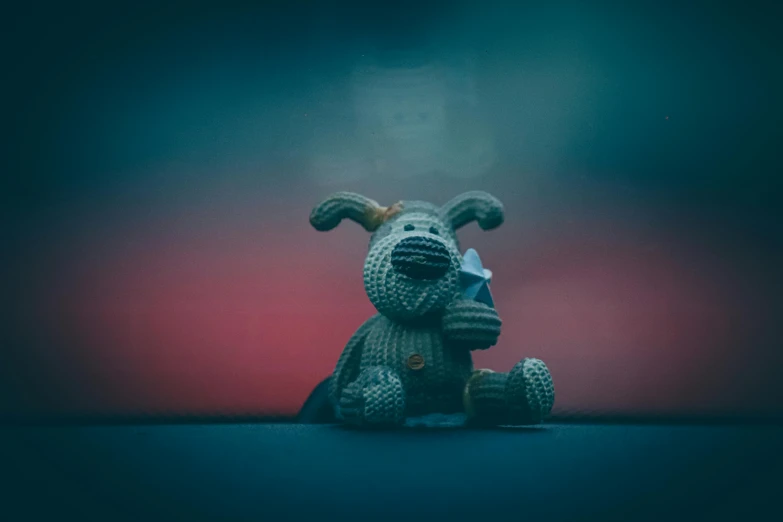 a stuffed toy dog sitting on a blue table