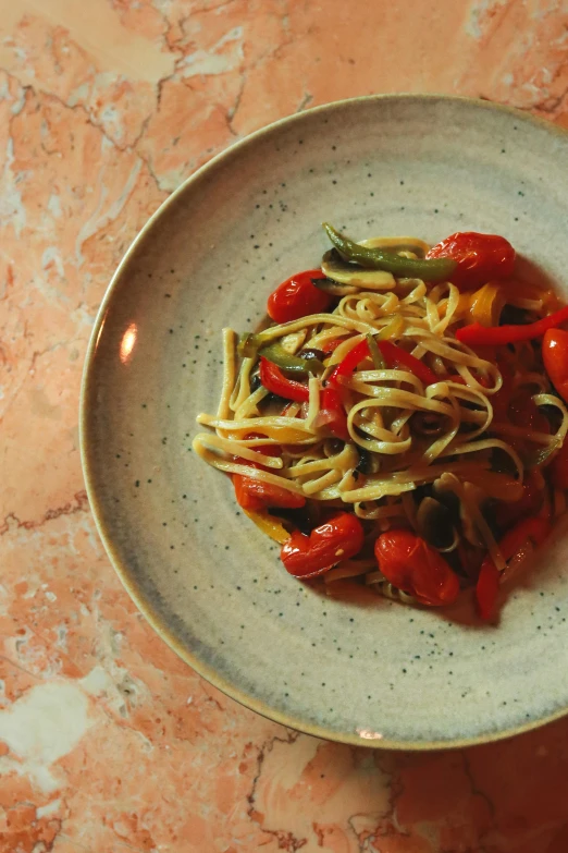 a pasta dish sitting on a white plate