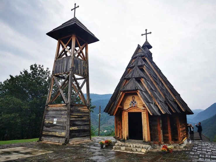 two wooden church like structures with a steeple