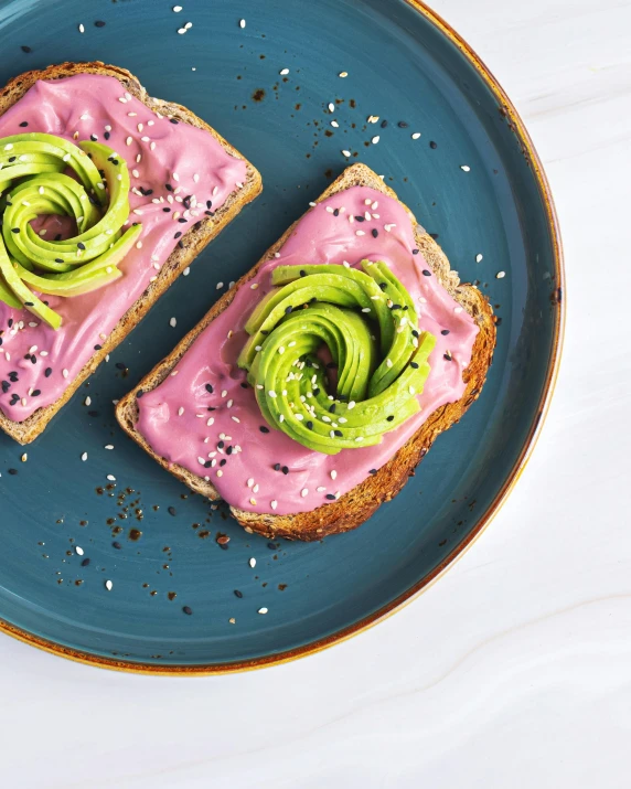 a healthy, pink bagel with avocado on it