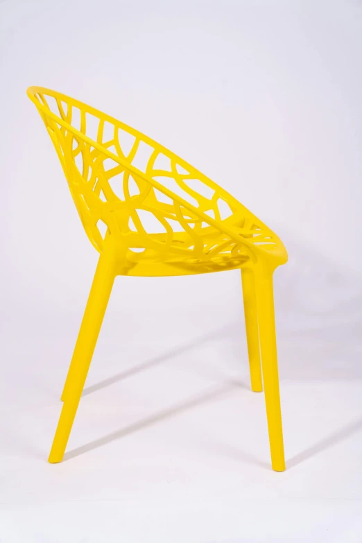 yellow plastic chair in front of a white background