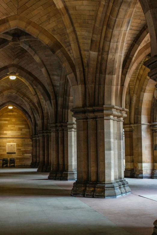 the interior of a large stone building with arched arches