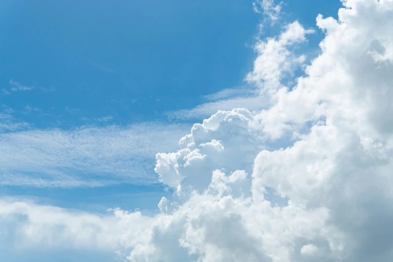 some clouds and a blue sky with jet liners in flight