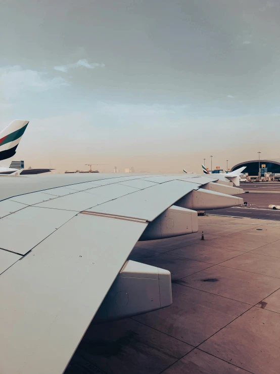 two airplanes on an airport tarmac next to each other