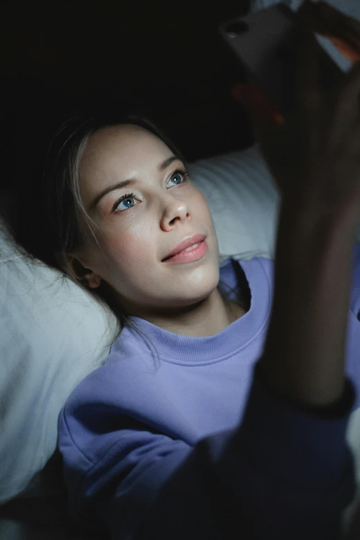 woman laying in bed with a remote control