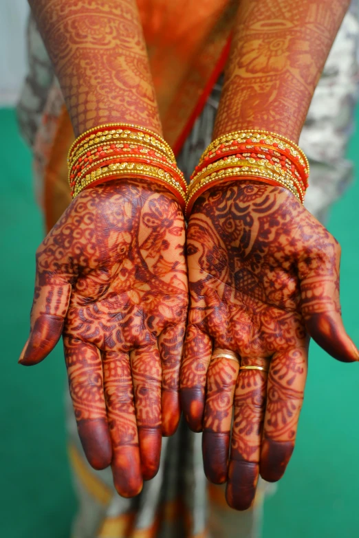 the hands of a woman holding soing covered in hendi