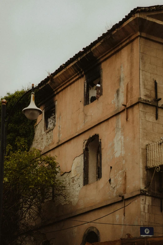 an abandoned house with boarded windows and rusty roof