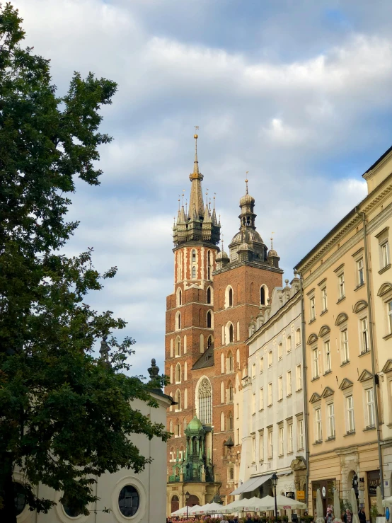 a tower of an old church in the middle of a town