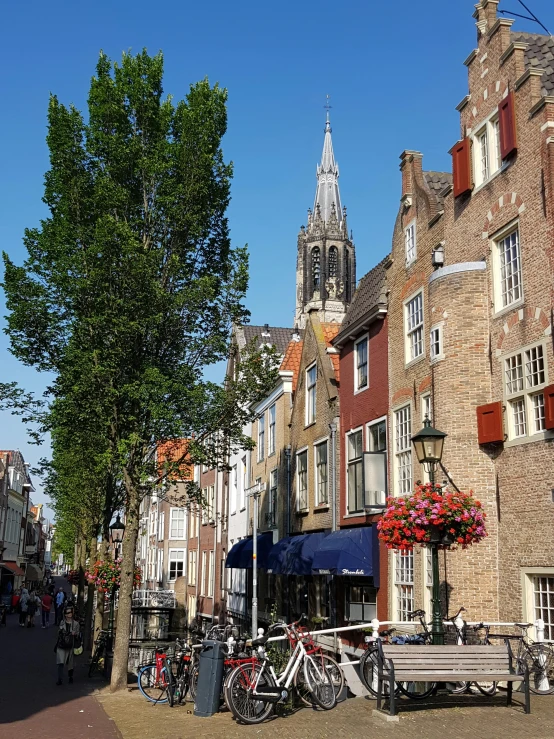 a row of brick buildings and bicycles lined up on the sidewalk